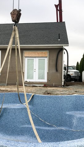 30-ton crane setting pool 60 feet over the house